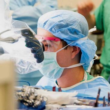 Surgeon operating through microscope