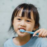 Young dental patient brushing