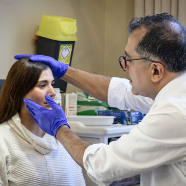 maxillofacial consultant examining patient